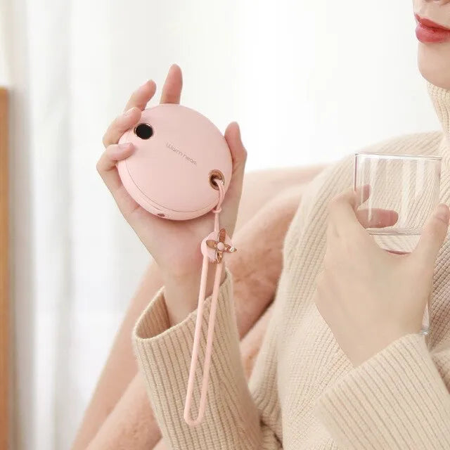 Green hand warmer power bank with digital display showing 5000mAh capacity and heating function