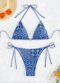 Women's green bandage style bikini swimsuit with split stitching detail on polyester fabric.