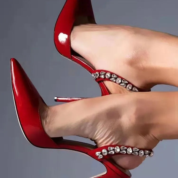 Women's pointed toe high heel sandals with rhinestone detail on patent leather upper.