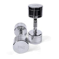 Silver electroplated steel dumbbell with hexagonal handle on a gym floor