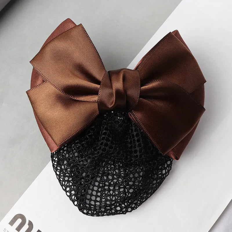 Professional flower bow headdress hair clip ornament on a work plate, shown in a selection of net and mesh colour variations.