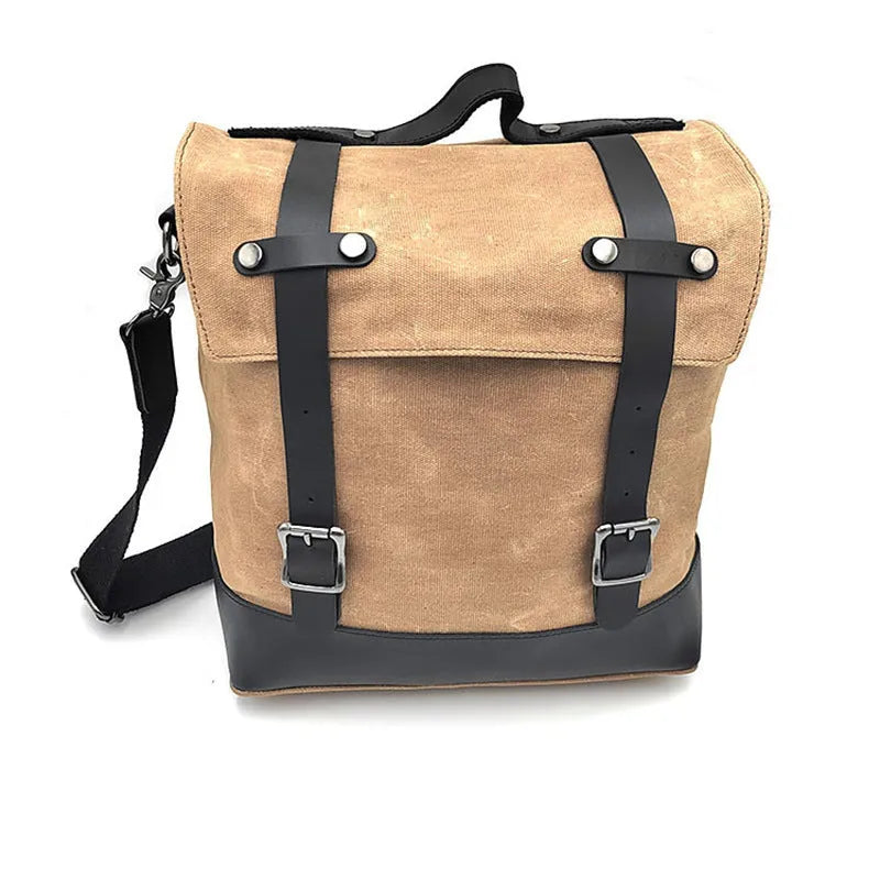 Black waterproof canvas motorcycle side pannier bag with leather trim mounted on a bike