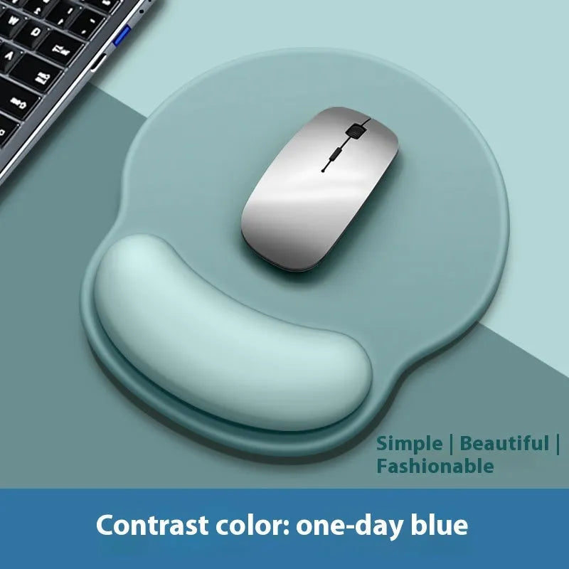 Silicone mouse mat with attached gel wrist support in a gradient blue colour on a desk.