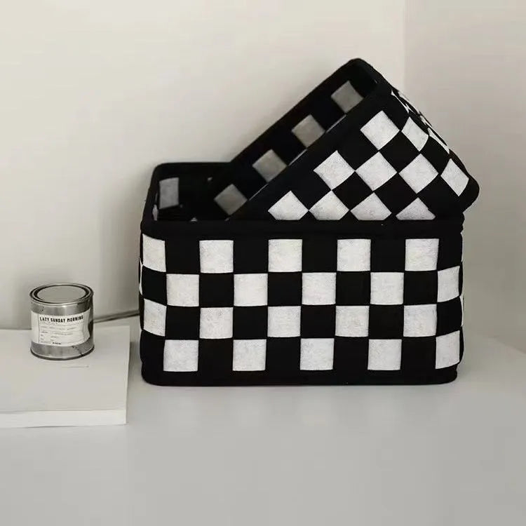 Grey and white checkerboard woven folding felt storage basket showing collapsible design