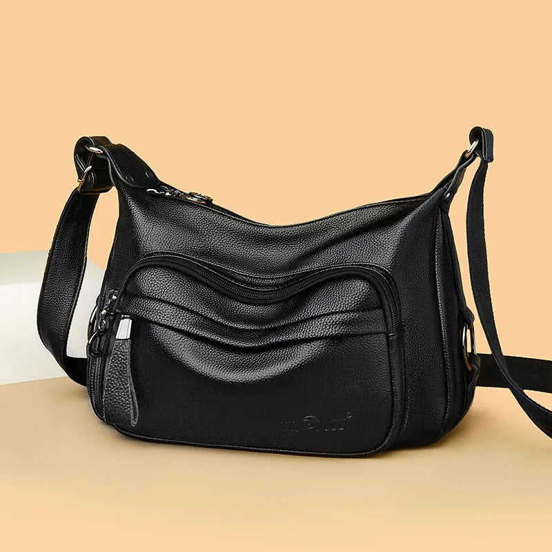 Large black PU shoulder bag with crossbody strap showing multiple internal compartments and zipper closure