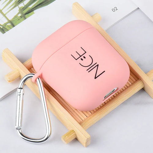 Black and pink Apple AirPods protective case with decorative back cover showing flower and smiley face designs