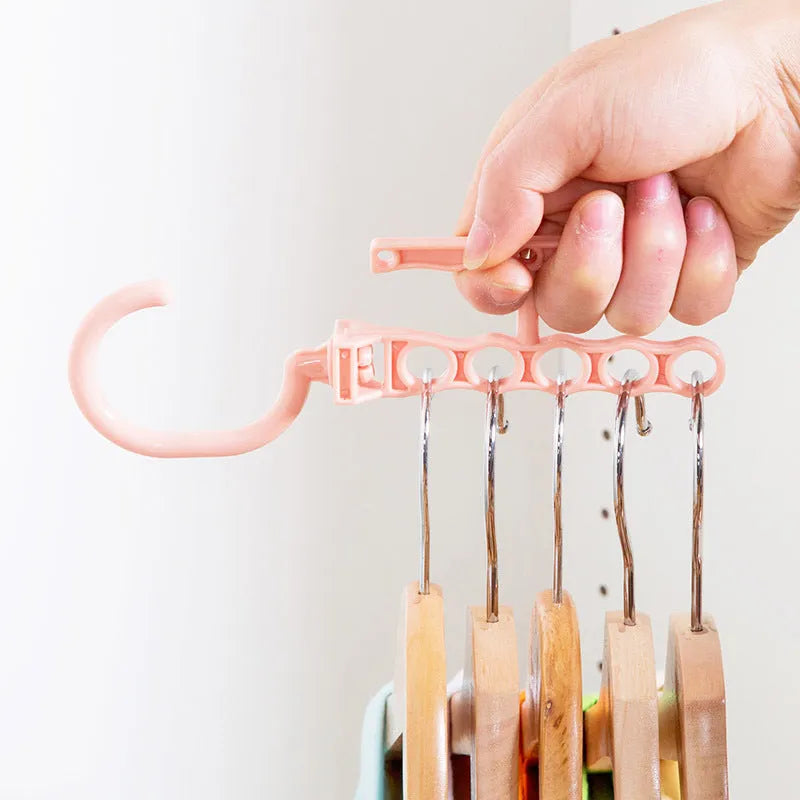 Blue revolving wardrobe hanger with five branches and folding handle for clothing organisation