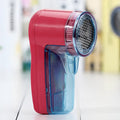 Portable electric clothing lint remover unit in a compact size.