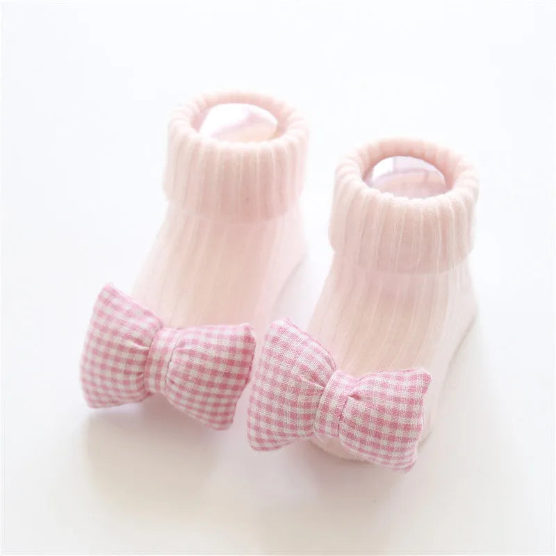 Cotton baby floor socks in various patterns including animal prints, stars, and bows for infants aged 0-3 months
