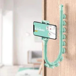 Flexible black suction cup phone holder bent into position on a desktop