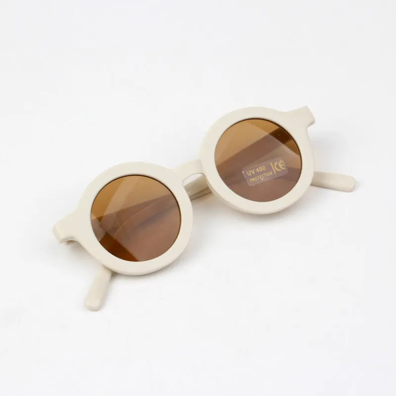 Children round frame retro mocha glasses on a child, showing the PC frame and resin lenses available in Beige, Brown, Green, Orange Red, Orange Yellow, Pink, and Purple colours