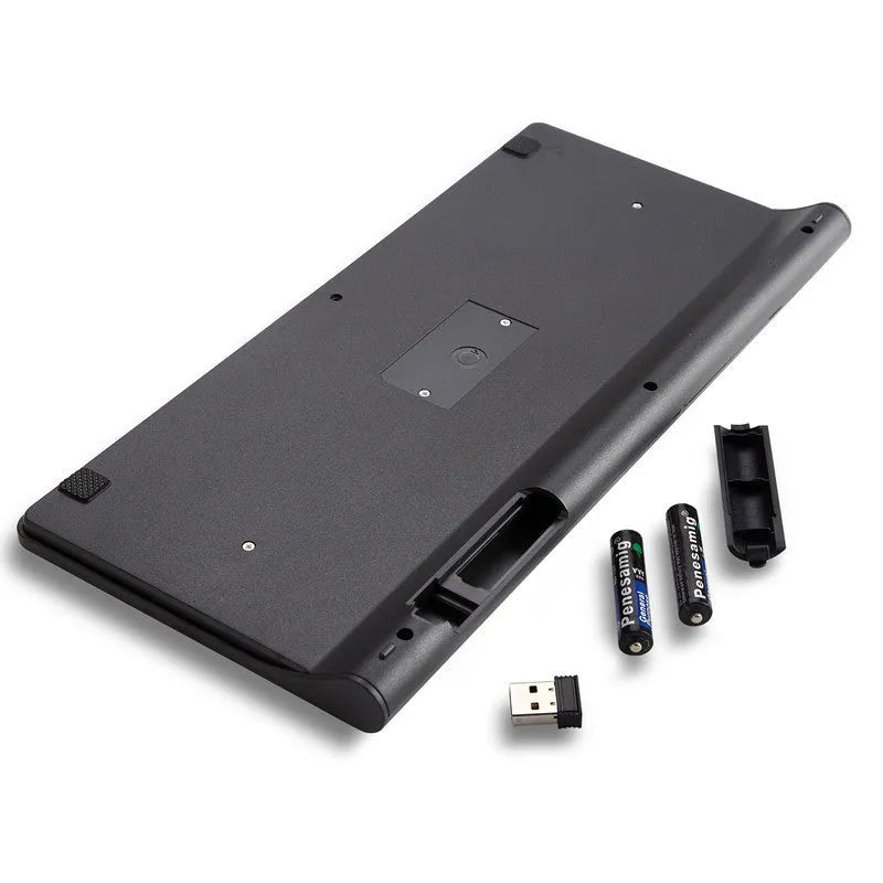 Black and white wireless keyboard and mouse set with USB receiver on a desk.