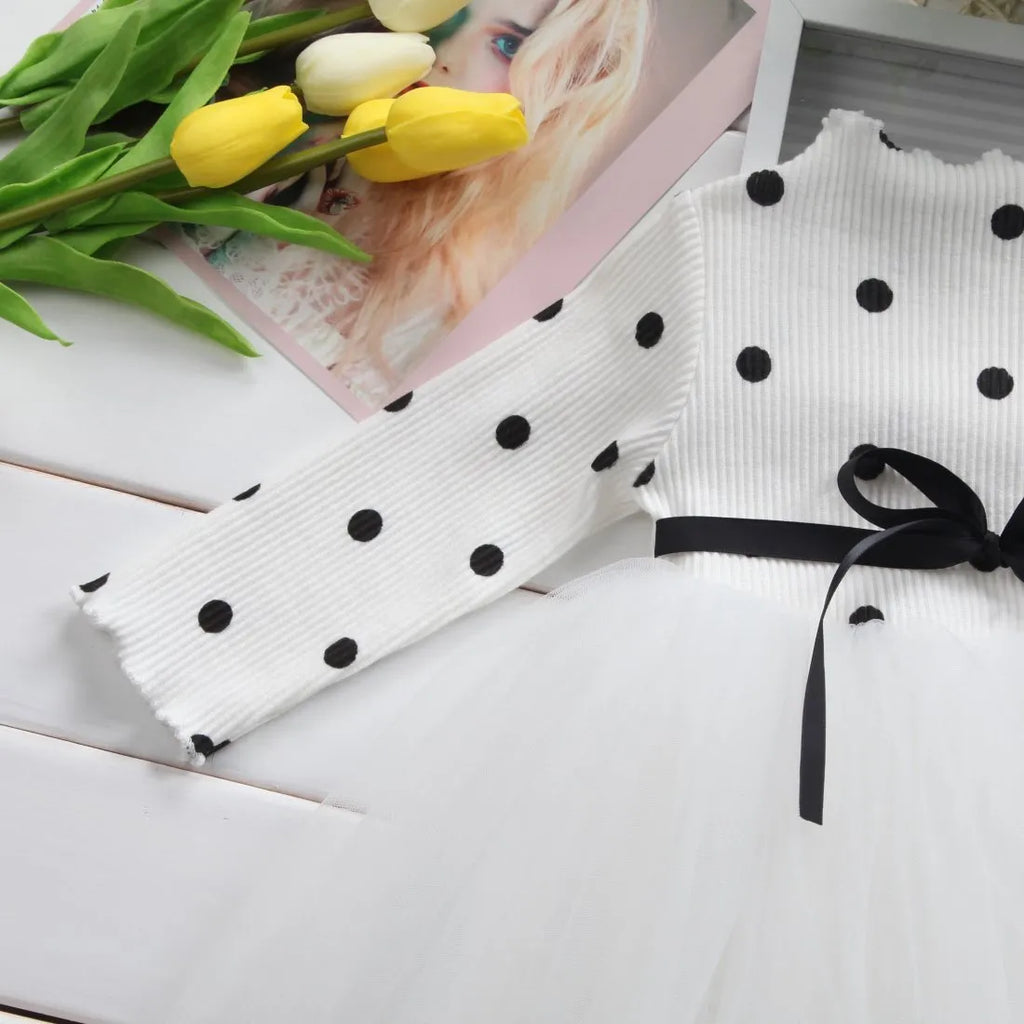 Baby girl wearing black lace tutu dress with long sleeves for birthday party