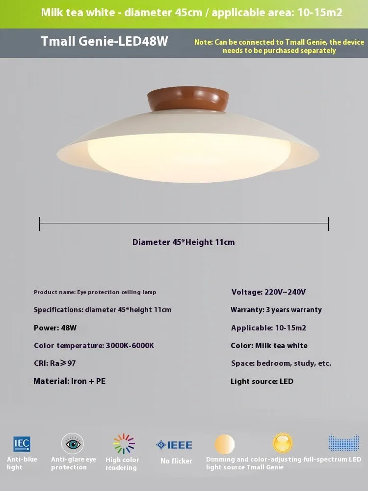 Modern minimalist flying saucer design ceiling lamp in cream yellow on a white ceiling.