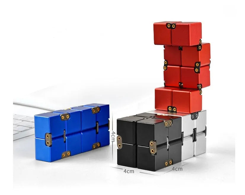 Silver zinc alloy infinity cube fidget toy with rotating segments shown on a flat surface