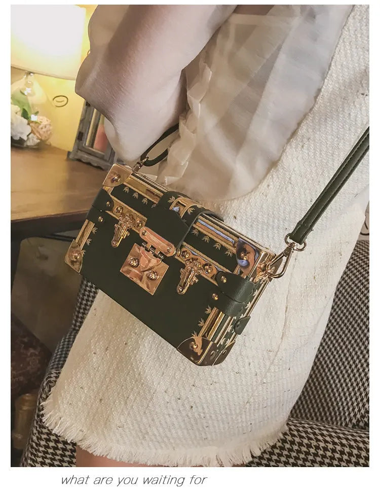 Hard black PU women's shoulder bag with flap closure and single adjustable cross-body strap.