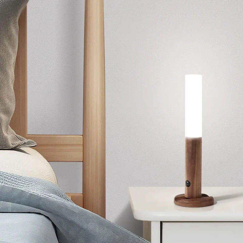 Compact wooden and acrylic motion sensor LED desk lamp on a desk