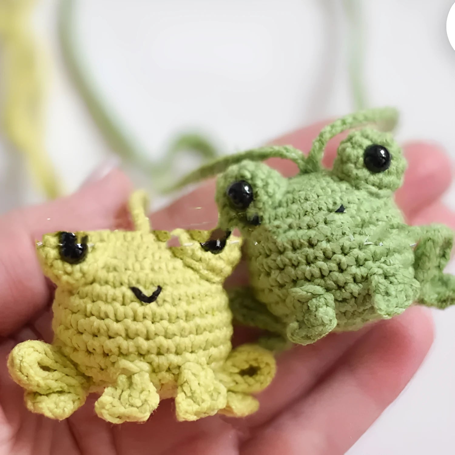 Handmade woven car pendant with a green frog plush doll hanging.