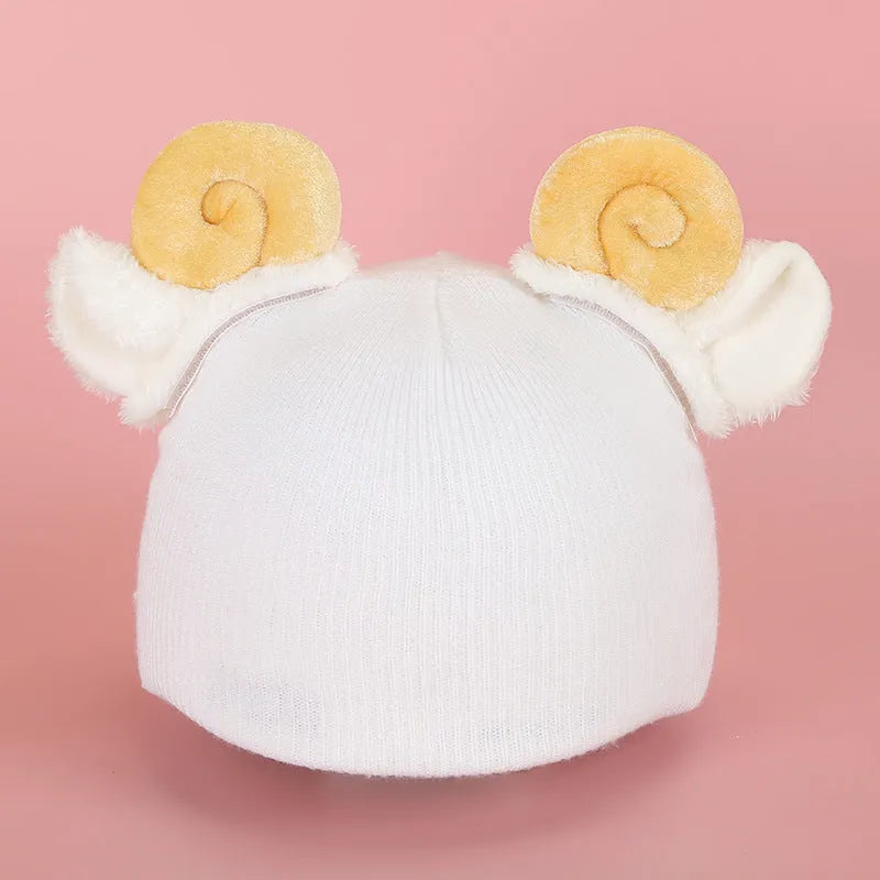 A plush fabric cartoon character helmet hat cover with attached ears on a white background.