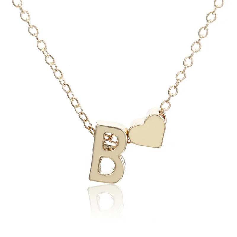 Peach heart shaped alloy pendant necklace charm in a gold colour finish on a model.