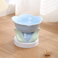 Blue floral patterned raised ceramic pet bowl for cats and dogs on a non-slip base.