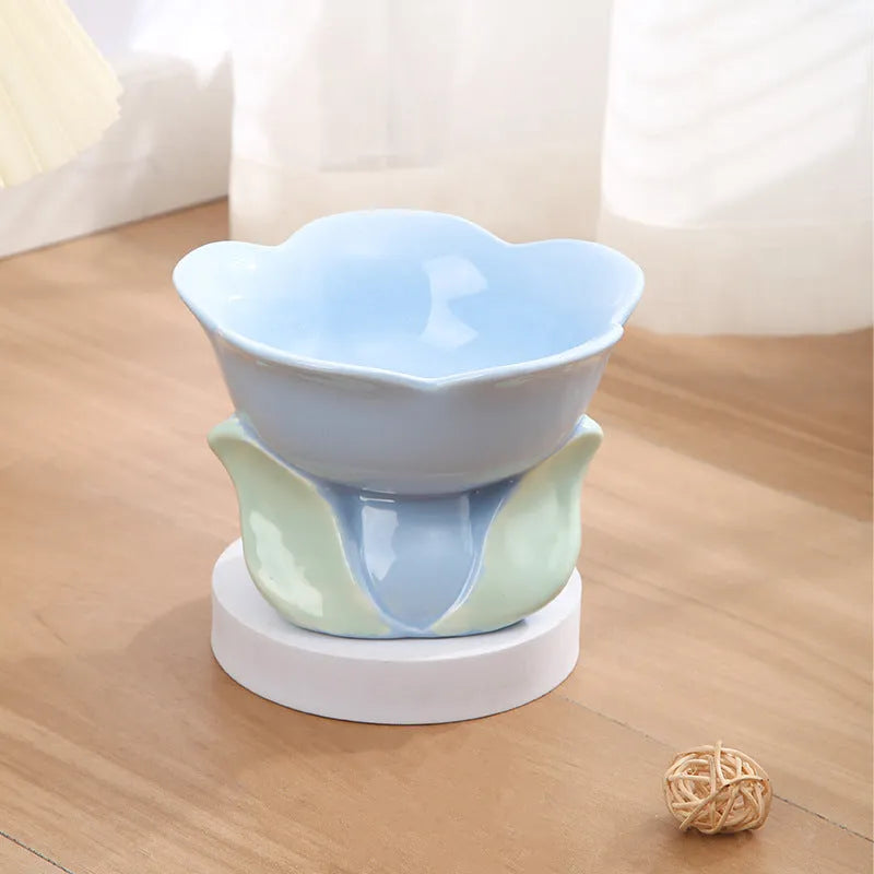 Blue floral patterned raised ceramic pet bowl for cats and dogs on a non-slip base.