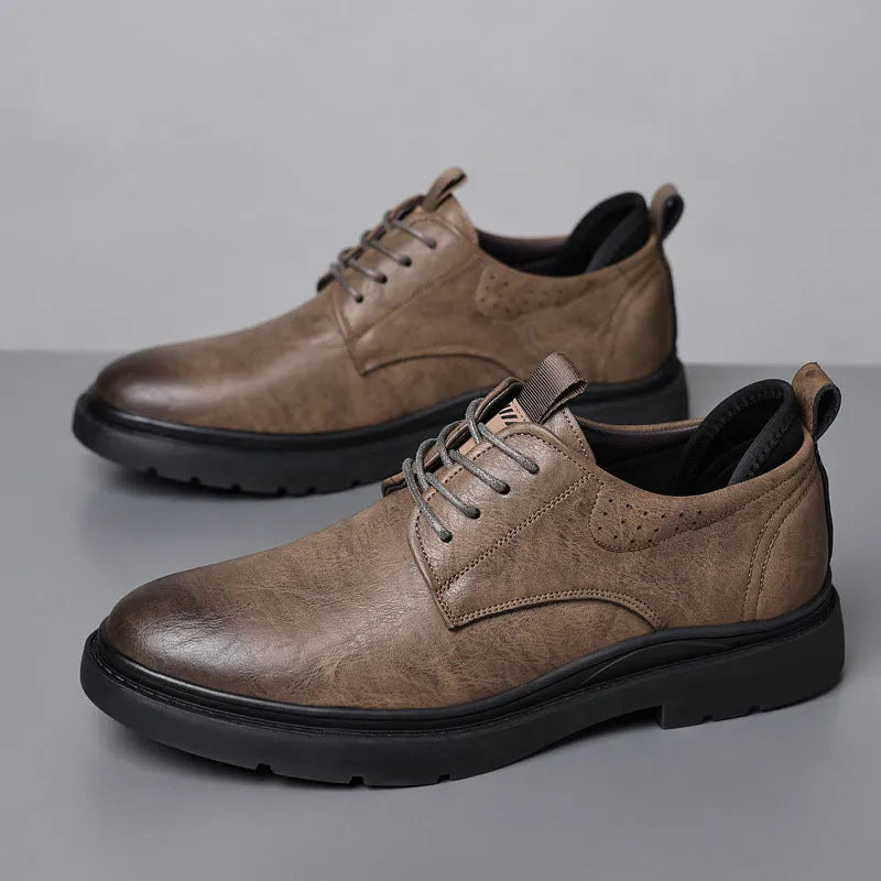 Men's black and brown leather casual sneakers with sewing line detail on the upper.