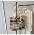 Blue woven straw shoulder bag with traditional weaving patterns and single shoulder strap