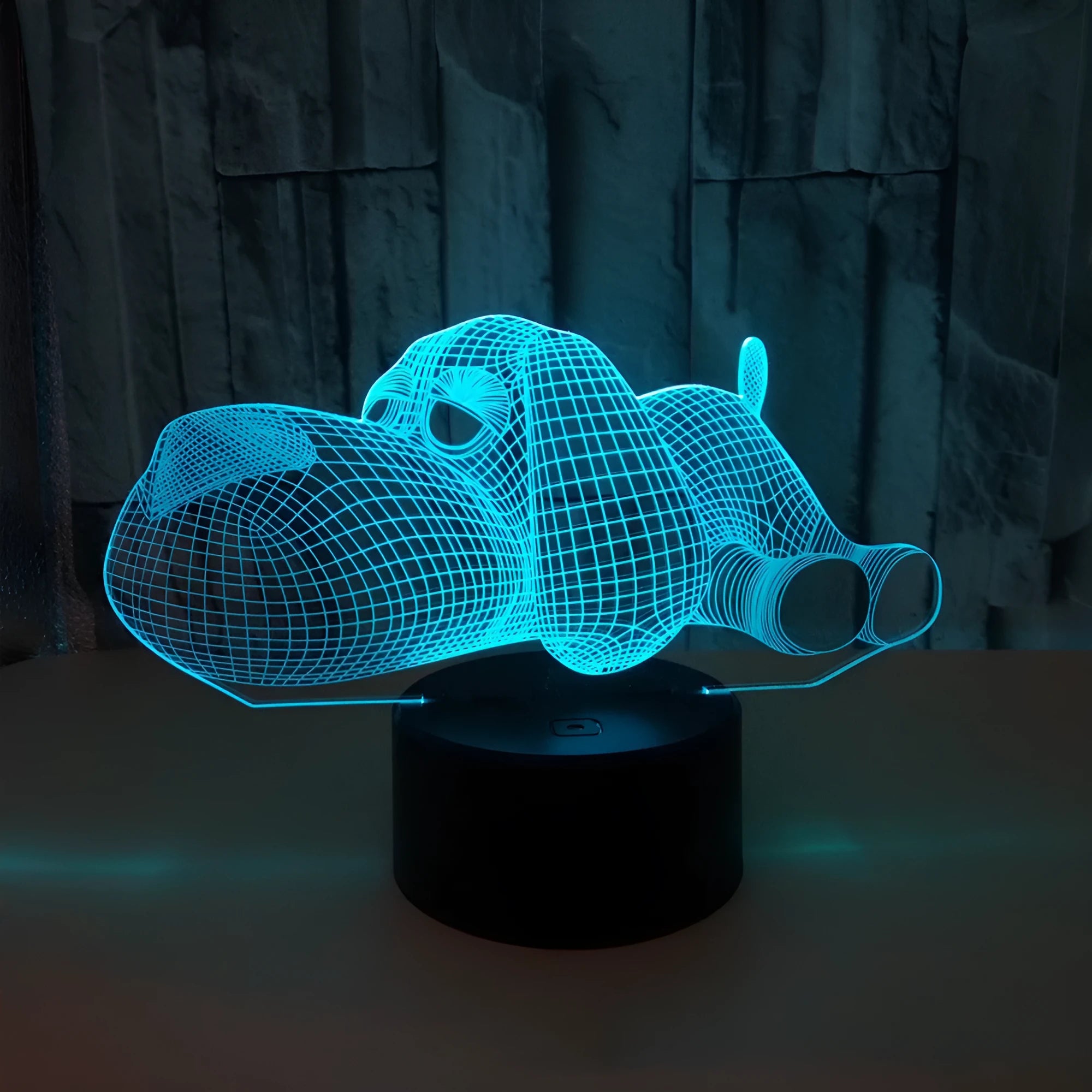 3D illusion dog lamp glowing with multi-colour light on a desk base