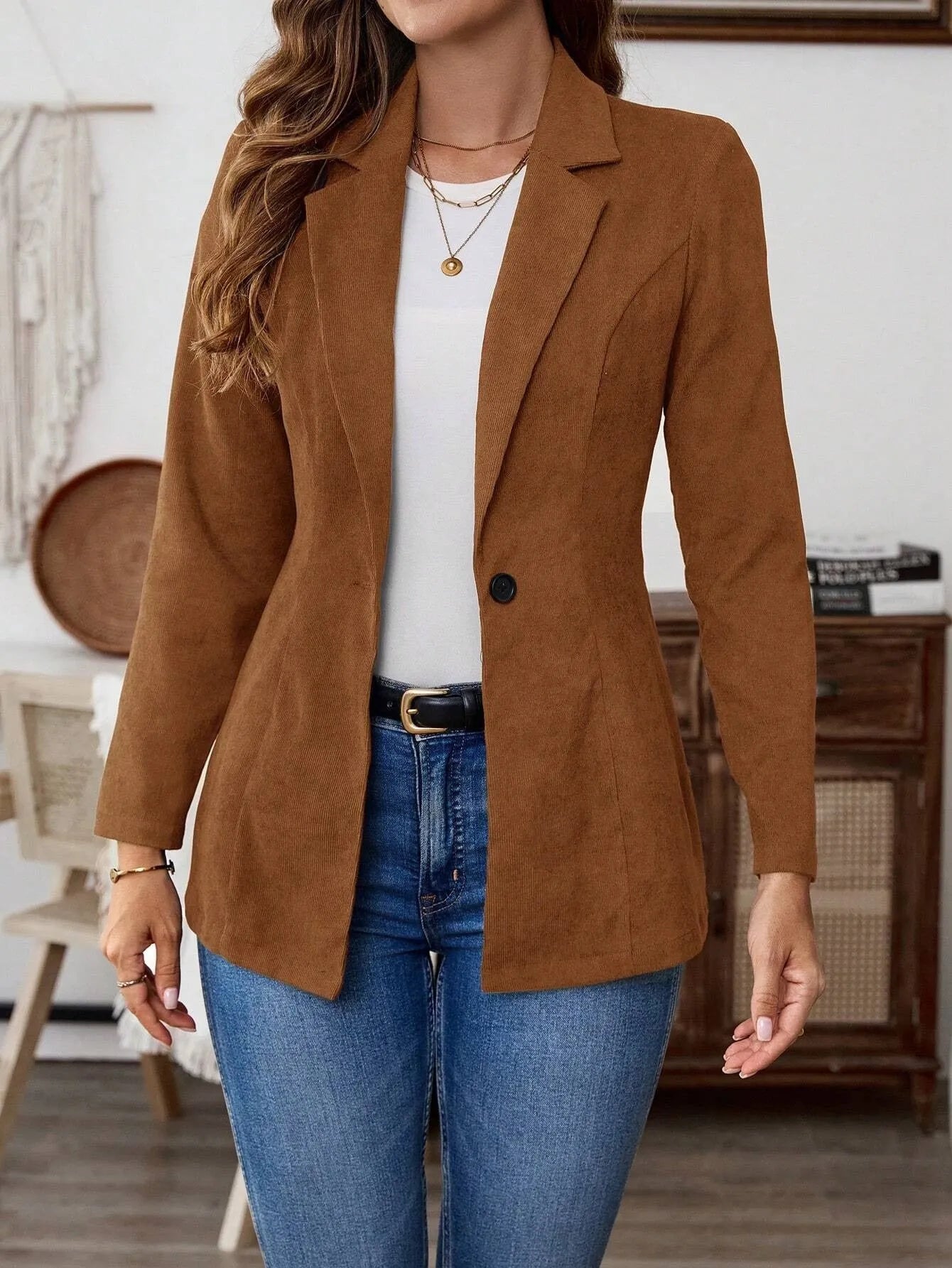 Brown men's single-breasted leisure suit coat with lapel collar on a hanger.