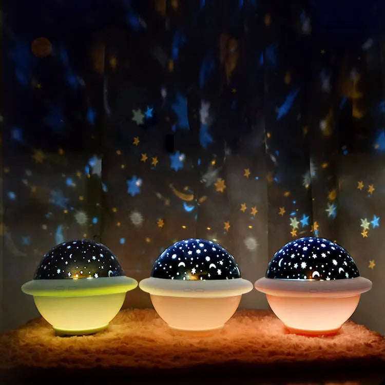 UFO-shaped starry sky projection night light in pink, white or green on a surface