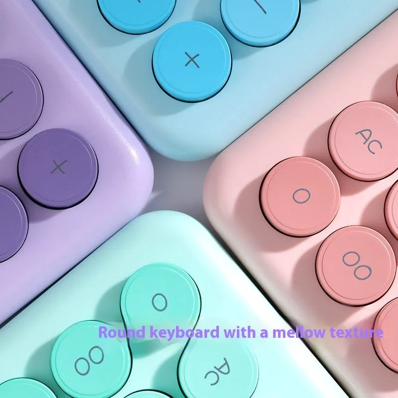Dopamine gradient colour desk calculator in violet, pink, blue, and mint green on a desk.