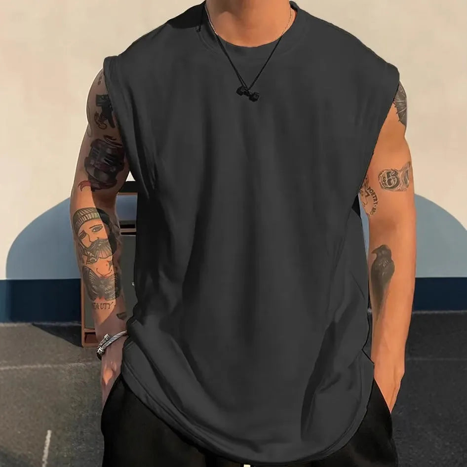 Men's solid colour loose fit cotton tank top on a hanger, showing straight hem and sleeveless design.