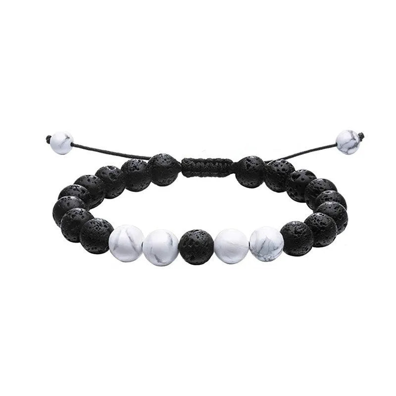 A pair of matte black agate bead bracelets with geometric design for him and her.