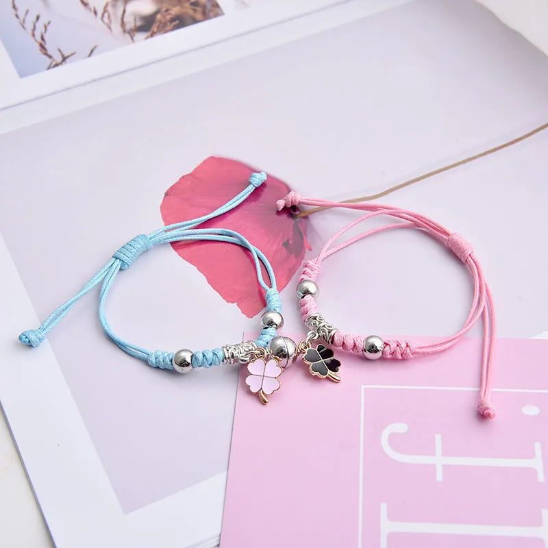 Pair of alloy suction bracelets with engraved symbol choices including crown, love lock, and clover.