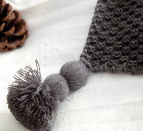 Nordic fringed knit ball acrylic blanket in beige colour showing texture detail and 130x170cm size