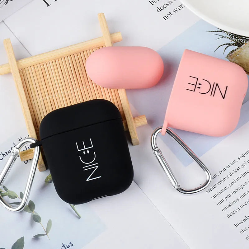 Black and pink Apple AirPods protective case with decorative back cover showing flower and smiley face designs