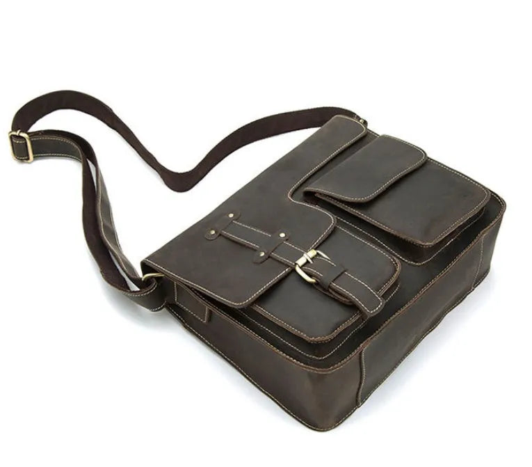 Brown leather vintage messenger bag with flap closure, antique buckle, and adjustable crossbody strap.