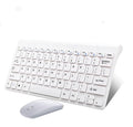 Black and white wireless keyboard and mouse set with USB receiver on a desk.