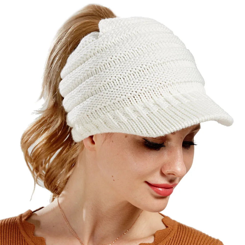 Women's knitted ponytail beanie with hair hole opening in acrylic yarn, shown in beige colour