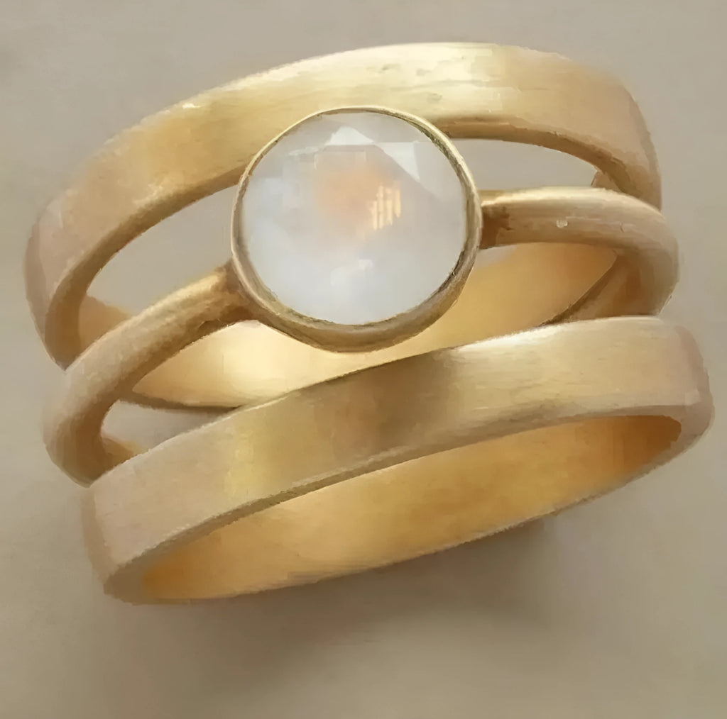Gold-plated geometric titanium steel ring with micro-inlaid white chalcedony detail shown on finger