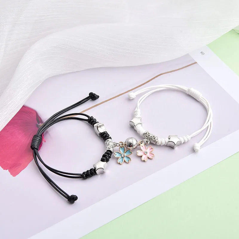 Pair of alloy suction bracelets with engraved symbol choices including crown, love lock, and clover.