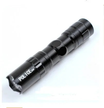 Black aluminium alloy mini LED handheld flashlight next to a AA battery