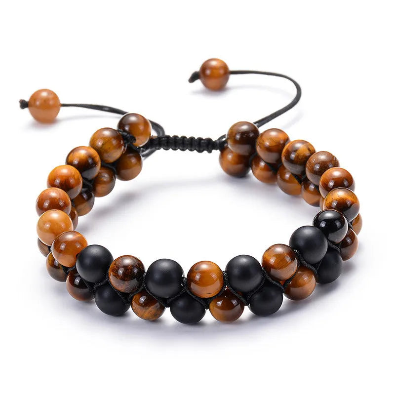 A pair of matte black agate bead bracelets with geometric design for him and her.