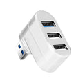 Black or white USB rotary splitter hub with four USB 3.0 ports on a desk.