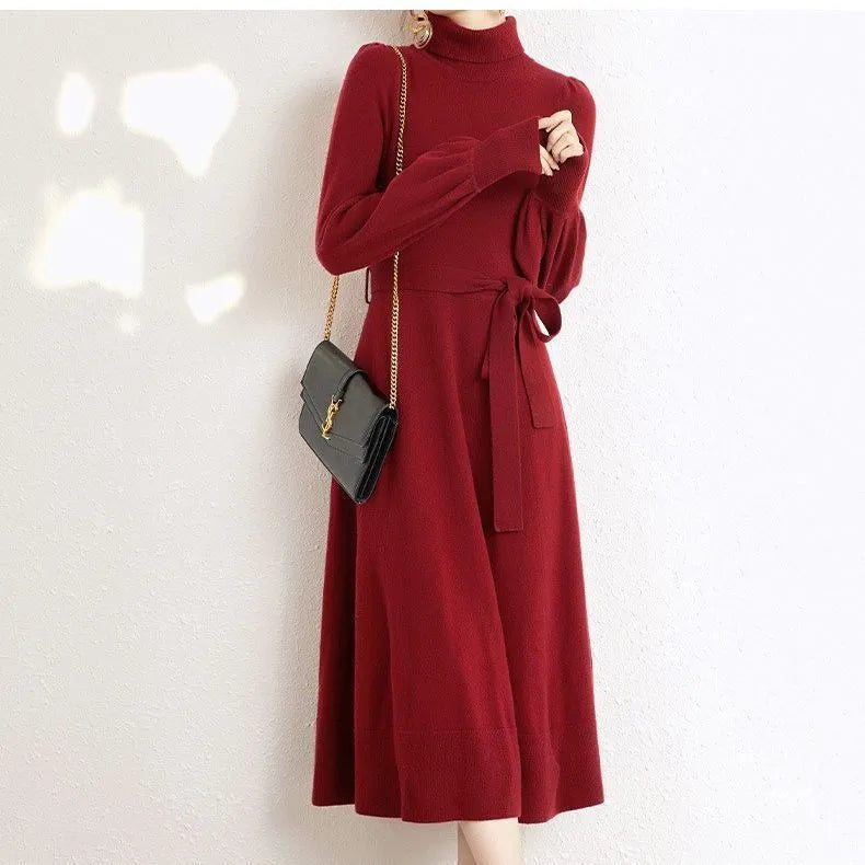 Women's knitted turtleneck dress with long sleeves, elastic waist, and a loose A-line skirt in a solid colour.