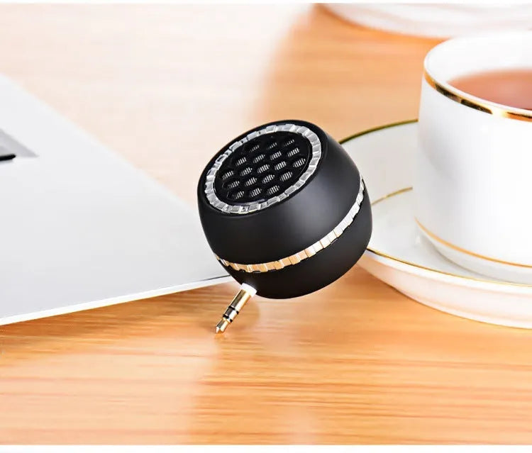 Universal external amplifier speaker in black, gold, or rose gold, showing input for 5V charger.