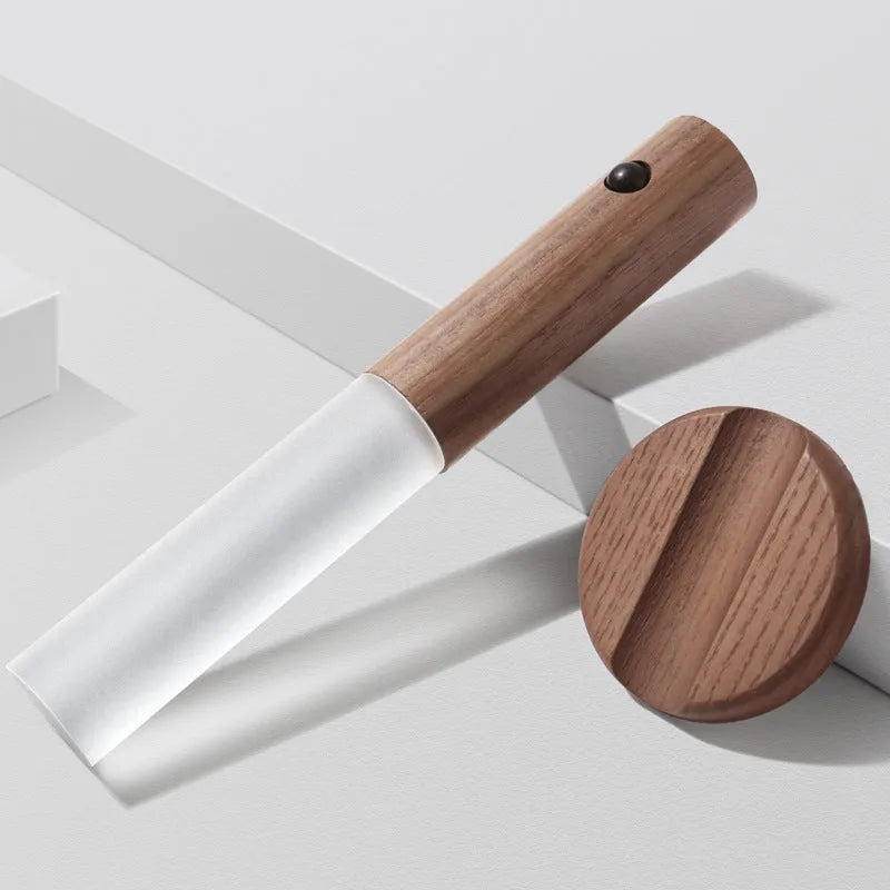 Compact wooden and acrylic motion sensor LED desk lamp on a desk