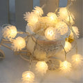 Warm white battery-powered LED pine cone decorative string lights shown in a 10-light or 20-light option.