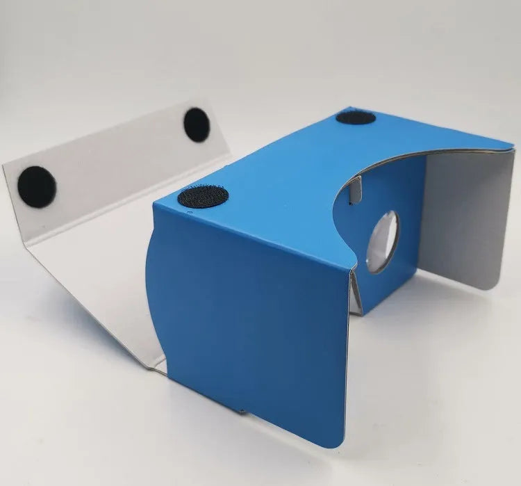 Pink and white cardboard VR headset for smartphones with adjustable strap and magnetic button.